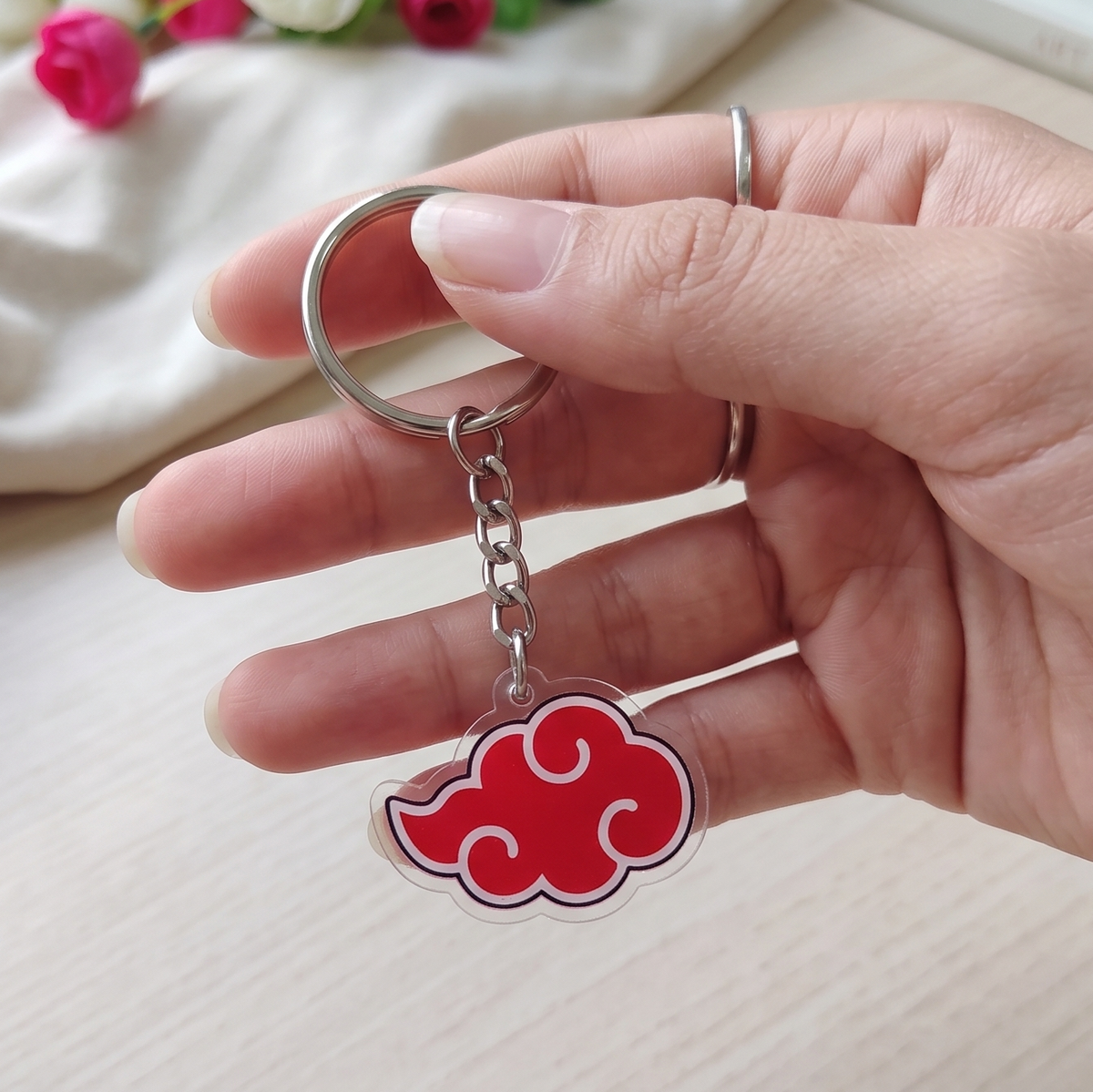 Hand holding a cute Demon Slayer chibi character stack acrylic anime keychain