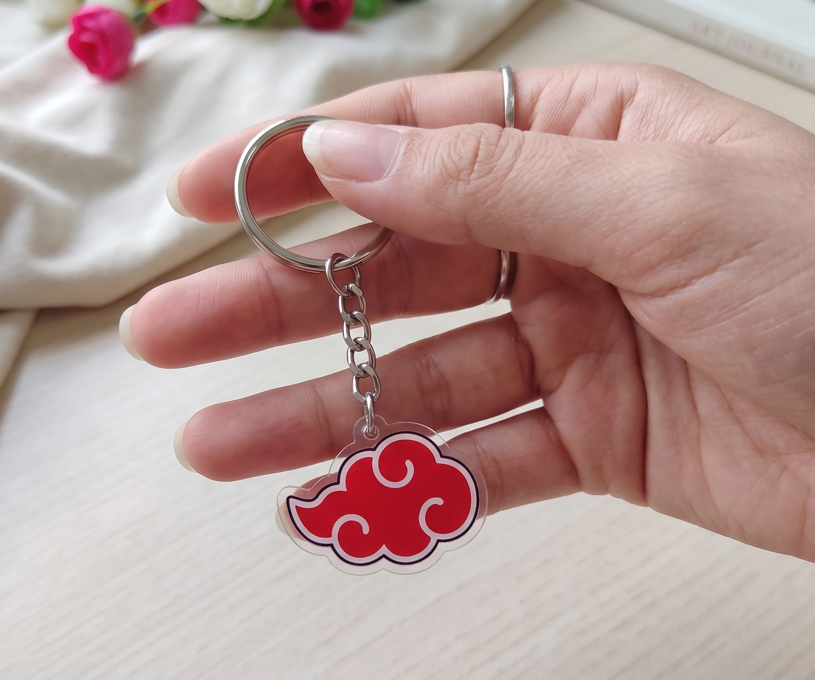 Hand holding a cute Demon Slayer chibi character stack acrylic anime keychain