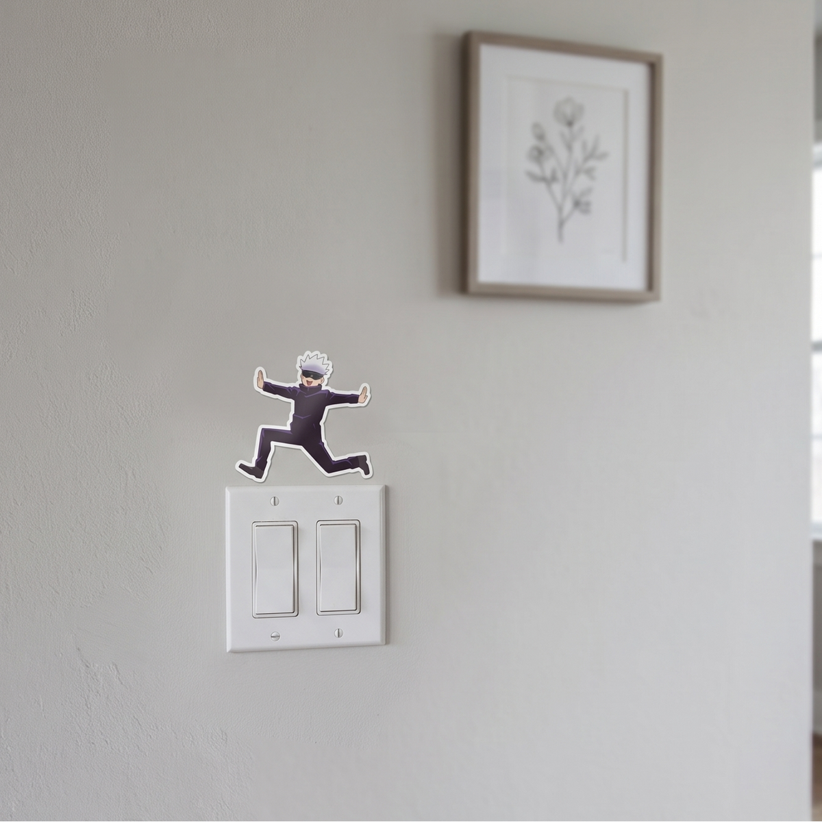 Satoru Gojo Jujutsu Kaisen anime wall decal sticker placed on a white wall above a light switch for room decor.