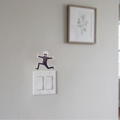 Satoru Gojo Jujutsu Kaisen anime wall decal sticker placed on a white wall above a light switch for room decor.