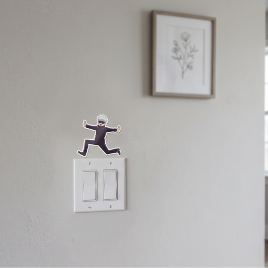 Satoru Gojo Jujutsu Kaisen anime wall decal sticker placed on a white wall above a light switch for room decor.