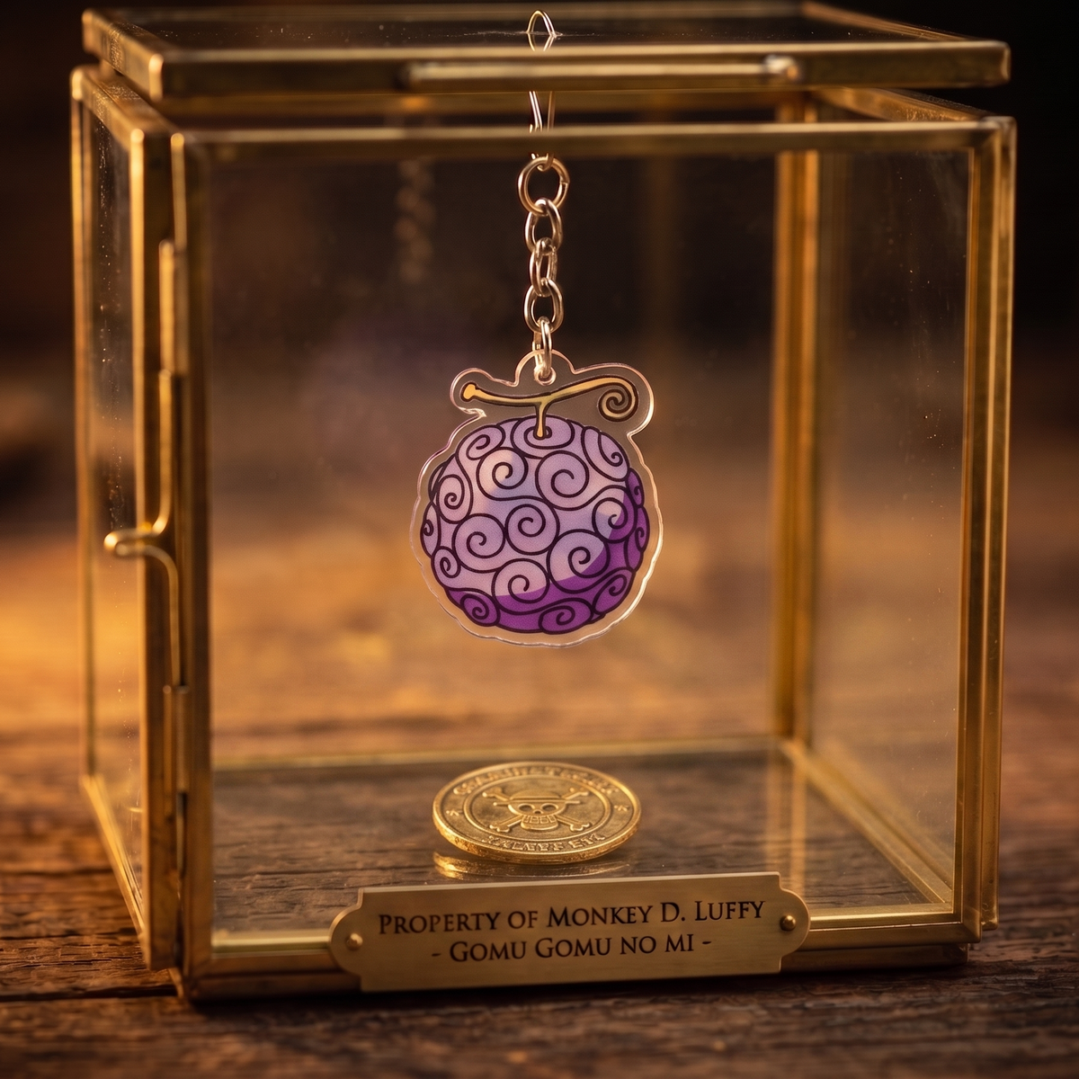 Gomu Gomu no Mi One Piece acrylic keychain hanging inside a glass display case with a gold pirate coin